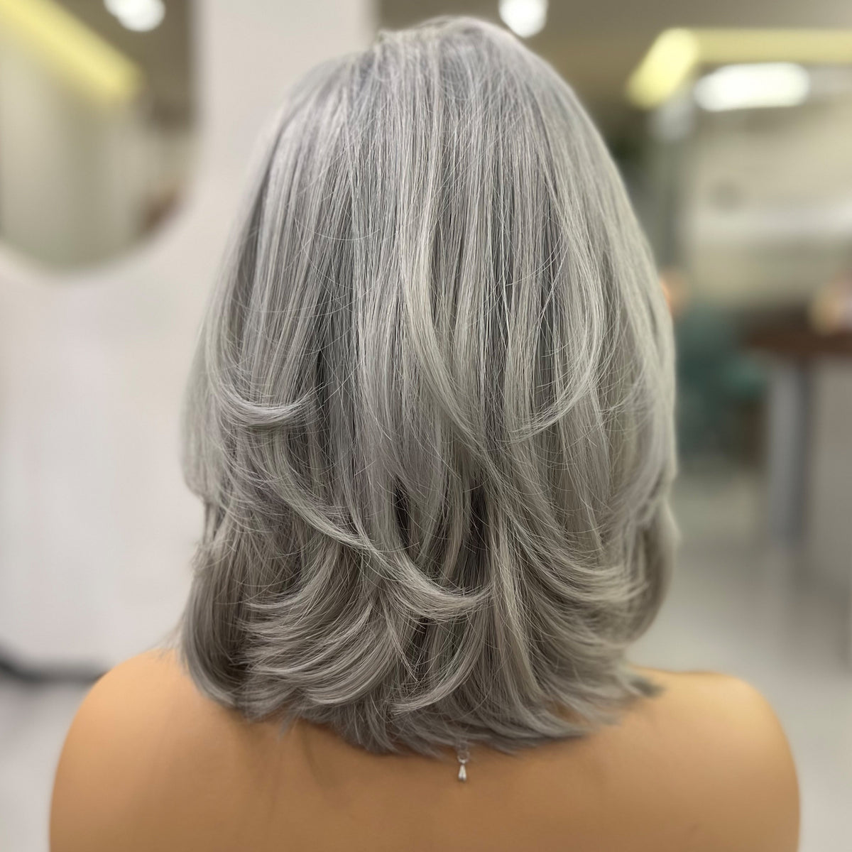 Colette wig back view 15 inch bob cut silver grey 140 density natural volume