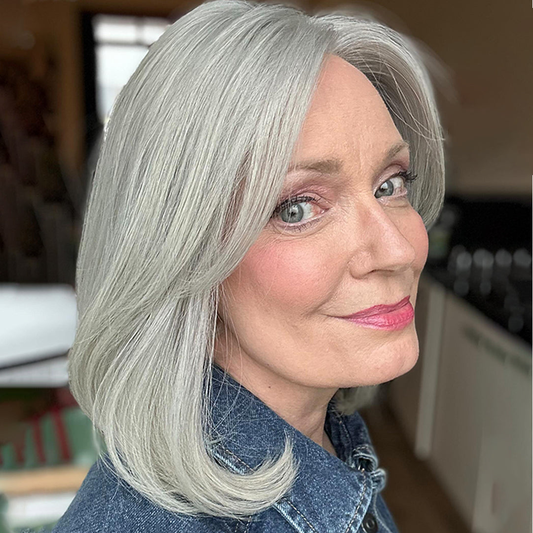 Woman wearing Colette silver grey wig 15 inch face framing soft layers natural look